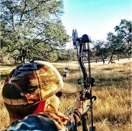 man shooting crossbow